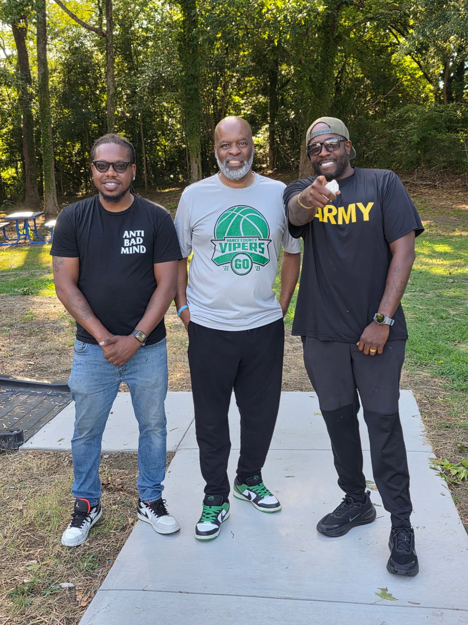 CJ Turrentine outdoors with two community leaders
